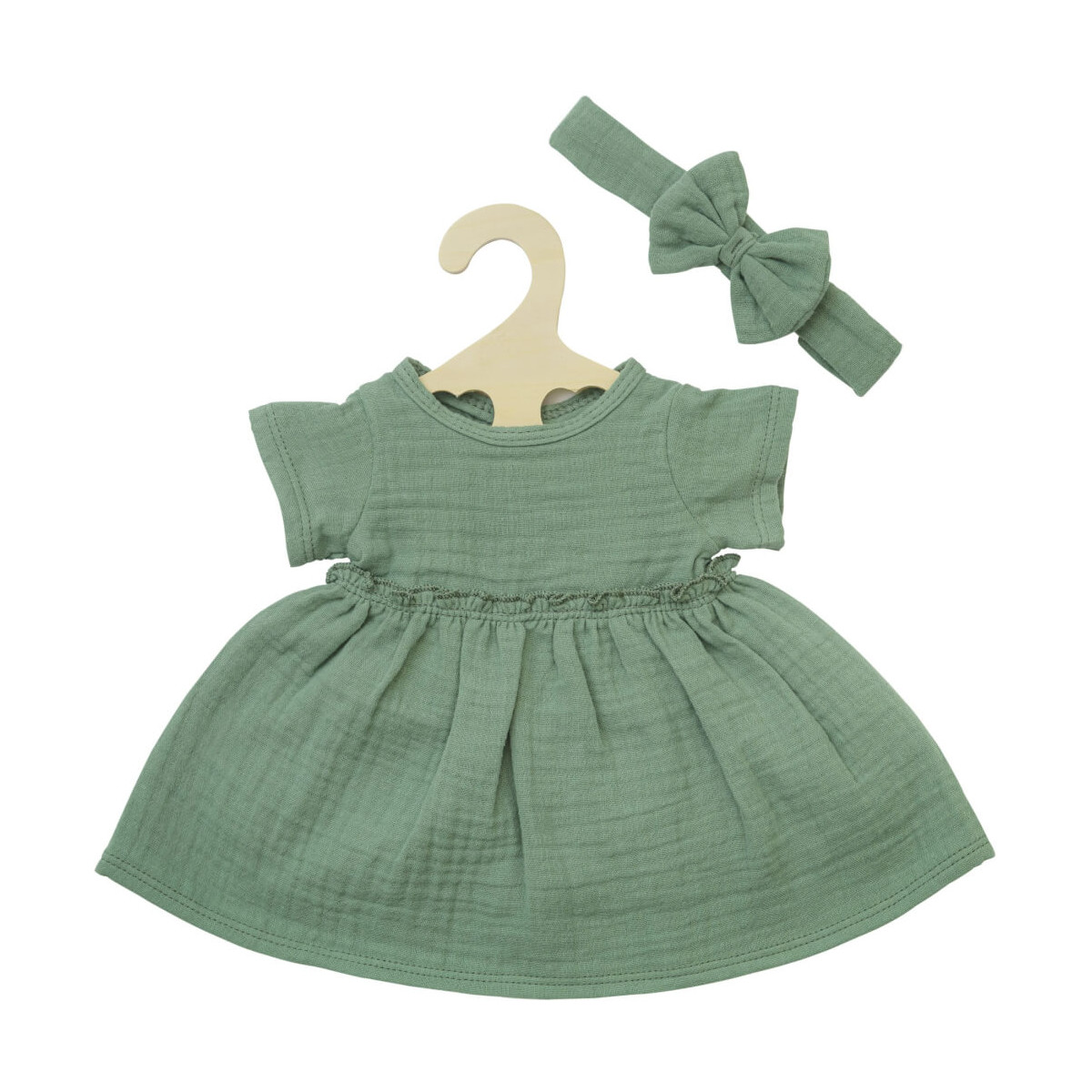 Grünes Babykleid mit kurzen Ärmeln auf Bügel, dazu passendes grünes Haarband mit Schleife.