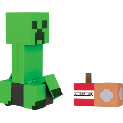 img_0:Ein Minecraft Creeper-Spielzeug steht neben einem pixeligen TNT-Block vor weißem Hintergrund.