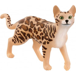 Spielfigur einer getupften Katze mit grünen Augen und aufrechten Ohren, die auf allen vier Beinen steht.