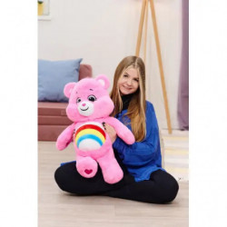 Rosa Teddybär-Plüschtier mit Regenbogen am Bauch und Herzen an den Füßen, sitzend.