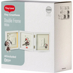 img_0:Weiße Box des Tiny Love Double Frame Kits mit Baby-Handabdruckrahmen und Kuscheltier für Babys ab 0 Monaten.